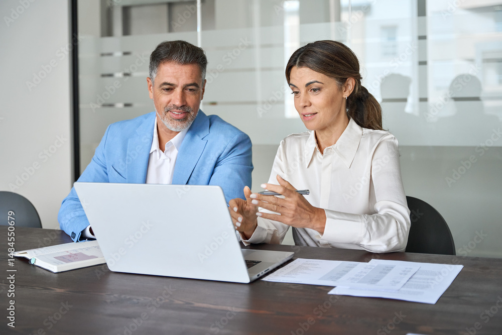 Two busy professional executives team business people working together on computer at office meeting. Female bank manager or financial advisor consulting corporate client investor using laptop. Two busy professional executives team business people working together on computer at office meeting. Female bank manager or financial advisor consulting corporate client investor using laptop.