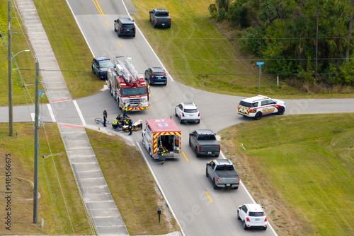 Canvas Print Car crash with first responders helping cyclist who was hit by car at accident site on American street