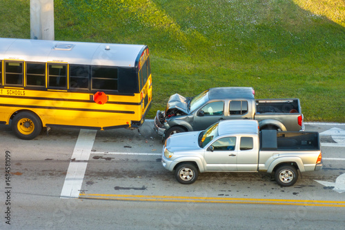 Traffic accident on American street in Florida. First responders helping victims of school bus and car crash on road in USA. Aerial view of emergency services responding to accident site