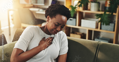 Obraz na plátně Breathing, chest pain or heartburn with black woman on sofa in living room of home for discomfort