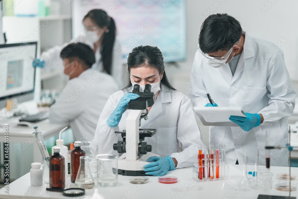 Medical research team conducting scientific experiments in a pharmaceutical laboratory, analyzing samples under microscopes to develop innovative medicine and healthcare solutions Medical research team conducting scientific experiments in a pharmaceutical laboratory, analyzing samples under microscopes to develop innovative medicine and healthcare solutions