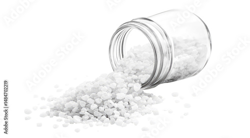 Coarse white crystals spilling from a tilted jar