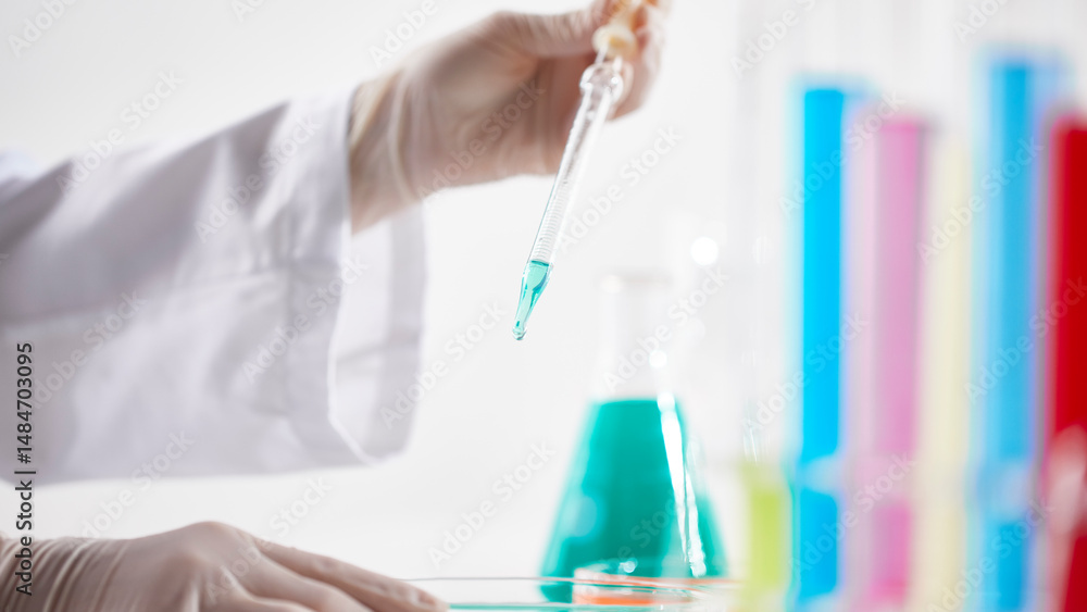 Fototapeta premium Hands Performing Scientific Experiments in a Modern Laboratory Setting.