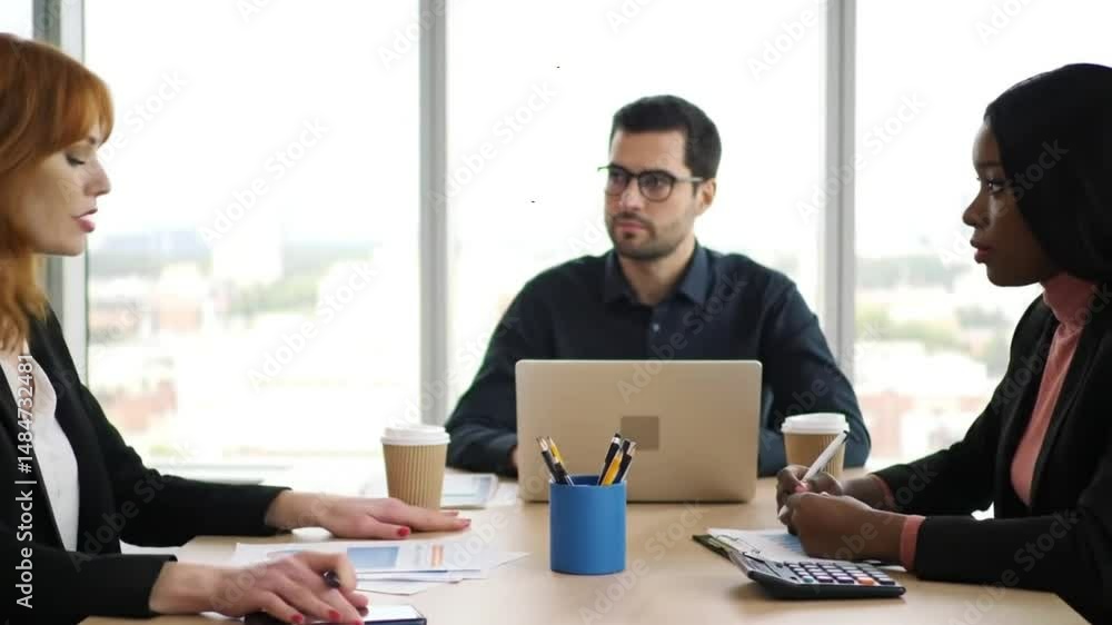 Diverse Business Team Collaborating in Modern Office Meeting Diverse Business Team Collaborating in Modern Office Meeting