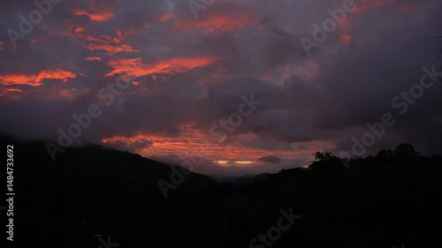 Majestic cloudy orange sunset in the mountains of Costa Rica, beautiful landscape