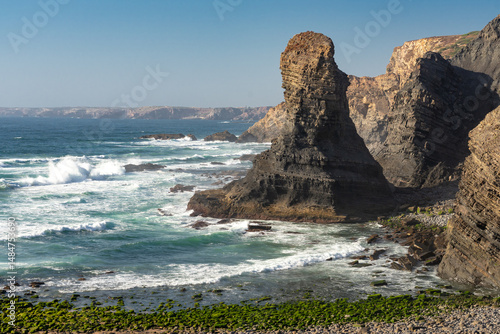 Penha Furada beach and cliffs in Vila do Bispo, Portugal, at sunset.