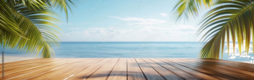 Fototapeta premium A wooden table stands ready for product display with palm leaves framing a view of the calm sea and blue sky at a tropical beach. Perfect for summer vacation vibes