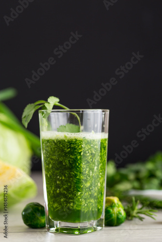 Valokuva Refreshing green smoothie with fresh vegetables and herbs