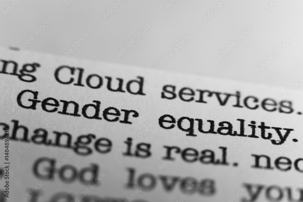 Fototapeta premium Gender equality. Text printed on a page. A piece of paper with a phrase written in retro typewriter font
