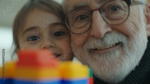 Grandfather and granddaughter share joyful moments together during playtime in a bright indoor setting