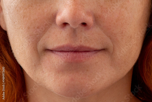 Cropped middle aged caucasian woman face showing nasolabial folds and skin texture
