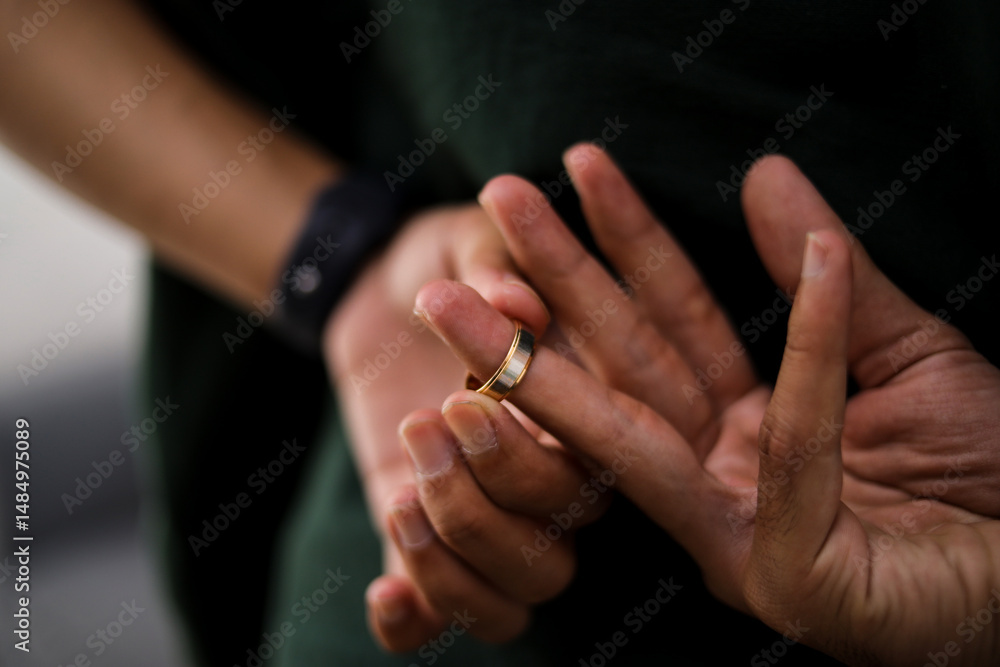 Fototapeta premium Man Taking Off The Wedding Ring Behind His Back, Cheating on Wife