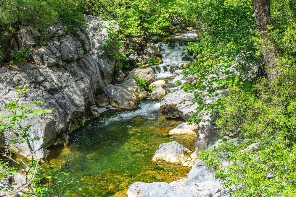 The scenic views of Ahmetler Kanyonu, situated along the River Karpuzçay, a mystical place where sculpted sandstone rocks tower above you and crystalline springs gush from nowhere in Antalya, Turkey The scenic views of Ahmetler Kanyonu, situated along the River Karpuzçay, a mystical place where sculpted sandstone rocks tower above you and crystalline springs gush from nowhere in Antalya, Turkey