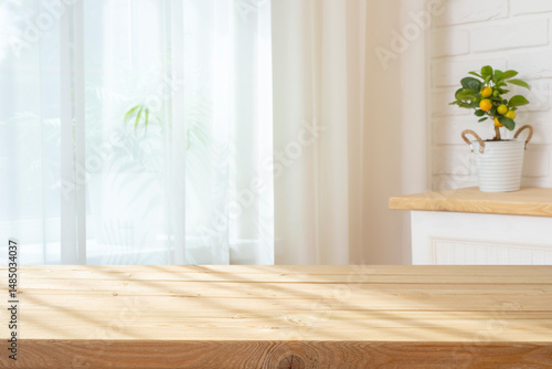 Wooden planks table with sunlight shadows for product display on curtained window interior background