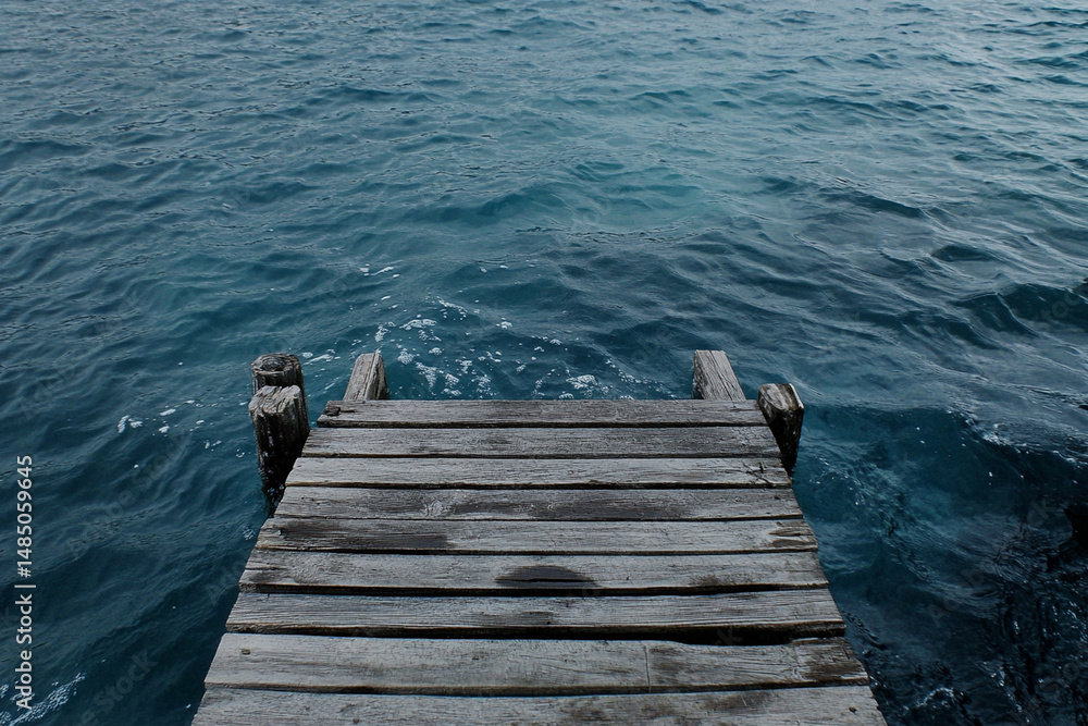Fototapeta premium Wooden bridge connecting two shores symbolizing relationships and unity over calm waters