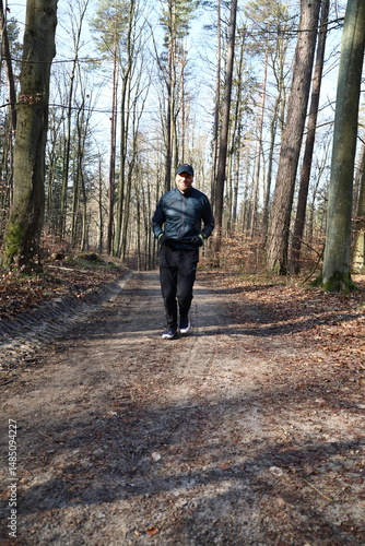 Wallpaper Mural Man running on a trail in the forest on a sunny day Torontodigital.ca