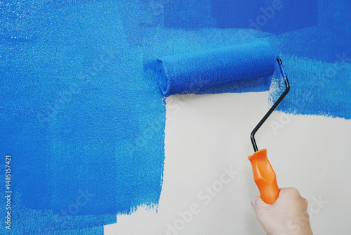 Photography Roller Brush Painting, Worker painting on surface wall Painting apartment, renovating with blue color paint