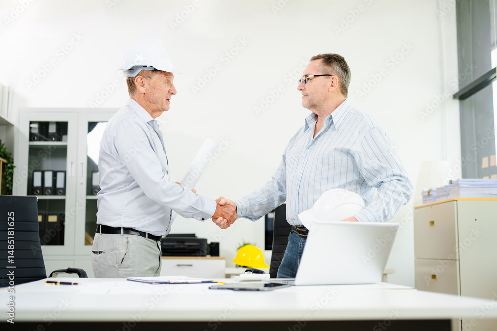 Fototapeta premium Construction engineers discussing plans with blueprints and digital tablet. Safety, teamwork, planning, and architecture