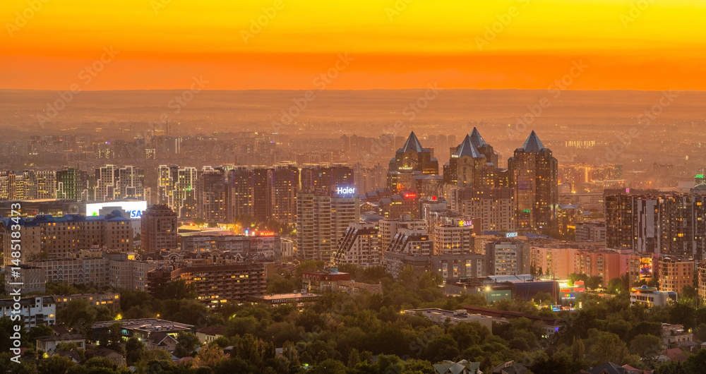 Naklejka premium Picturesque sunset over the business part of the Kazakh city of Almaty in May evening