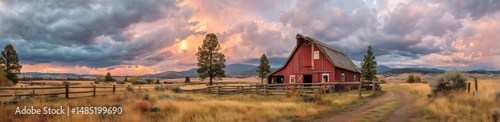 Sunset Over Red Barn in Rural Landscape With Golden Grass and Dramatic Clouds