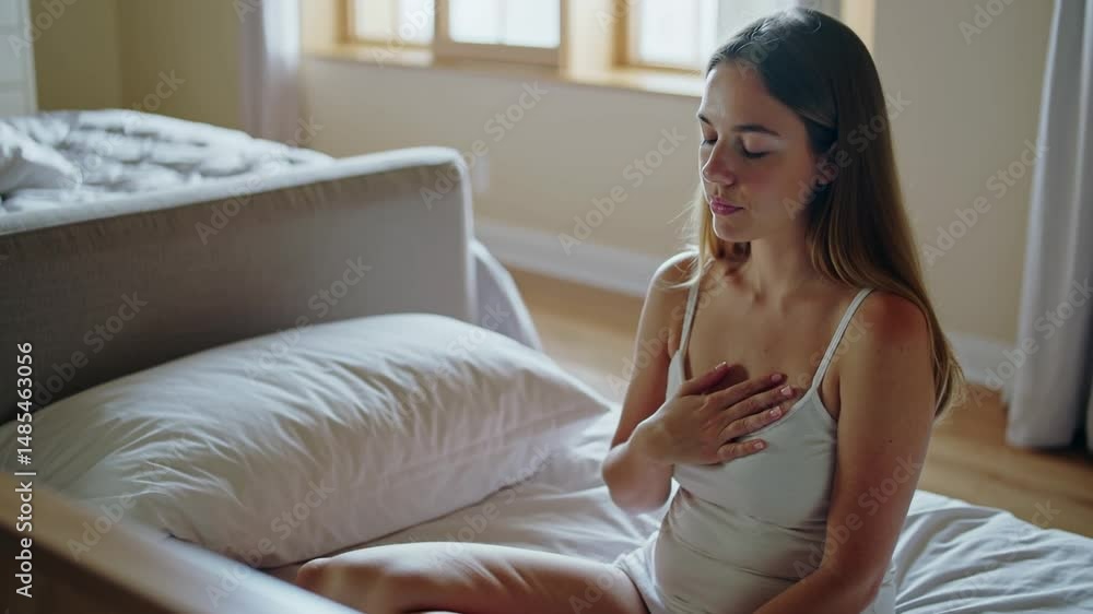 Young woman practicing self-care with mindful breathing in the morning Young woman practicing self-care with mindful breathing in the morning