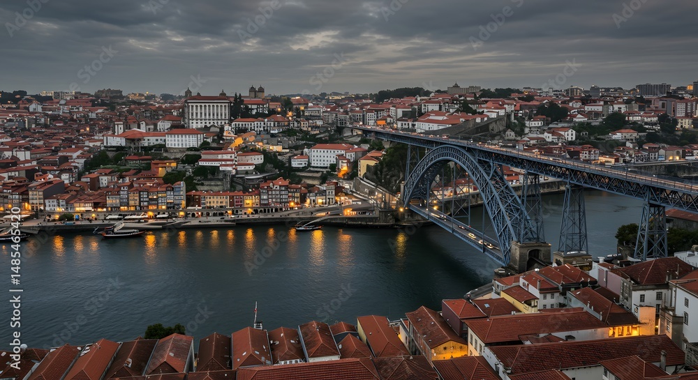 Obraz premium Cityscape View with River and Bridge Under Cloudy Sky at Dusk