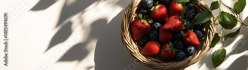 A Vibrant Arrangement of Fresh Berries Displayed in a Woven Basket under Natural Light