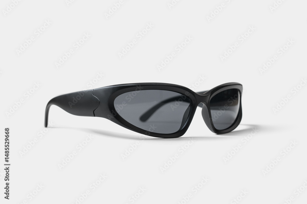 Fototapeta premium Vintage sport sunglasses with a white wraparound frame and dark lenses, isolated on white. Perfect for retro fashion, active lifestyle, or summer style themes.