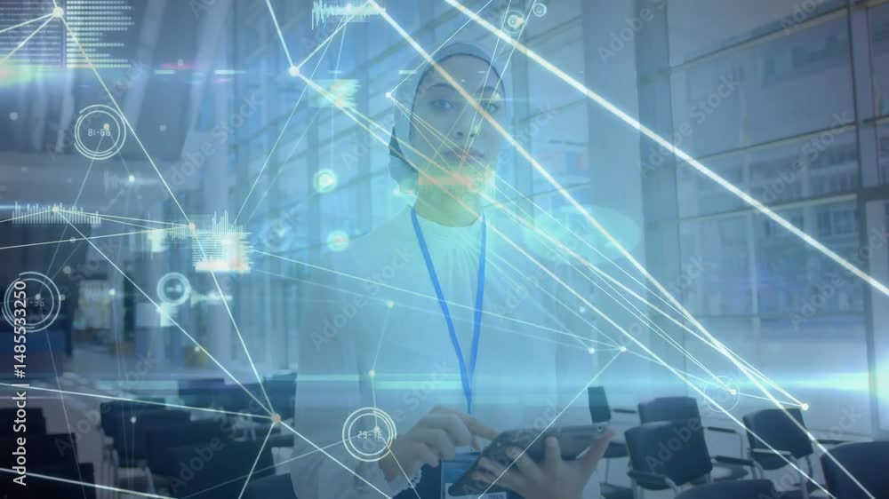 Woman tapping handheld tablet in office lobby, while viewing holographic technology network charts Woman tapping handheld tablet in office lobby, while viewing holographic technology network charts