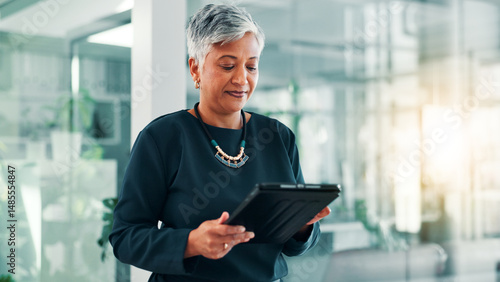 App, research or tablet with business woman in office for information, project management, report. Corporate, internet or review with mature employee in professional workplace for company development