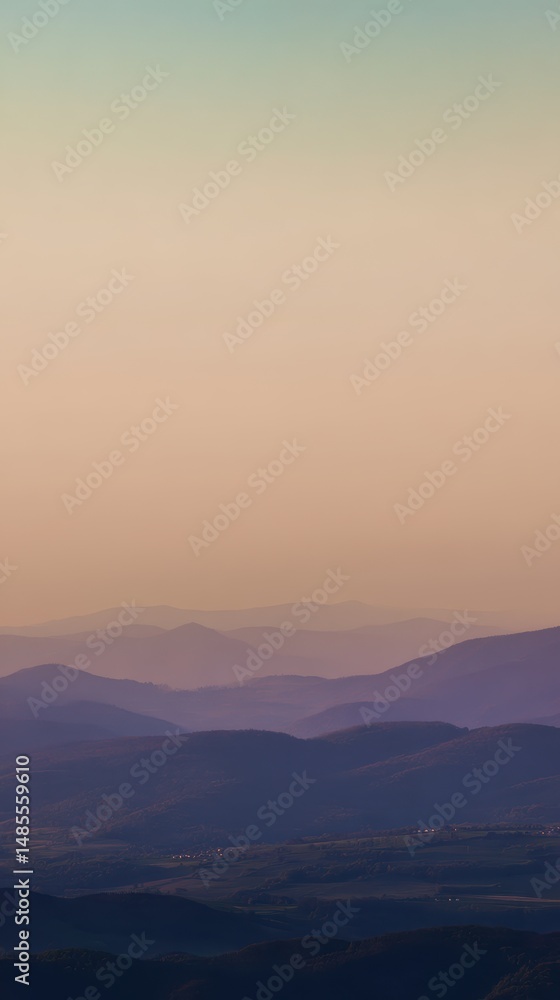Fototapeta premium Serene sunset landscape view with soft hues over layered rolling hills and distant mountains under a calm sky, creating a peaceful atmosphere for relaxation