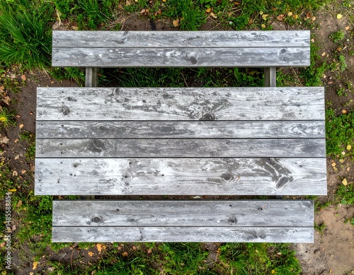 Wallpaper Mural Overhead view of rustic wooden picnic table in grassy park. Perfect for design projects needing a natural, weathered wood texture. Torontodigital.ca