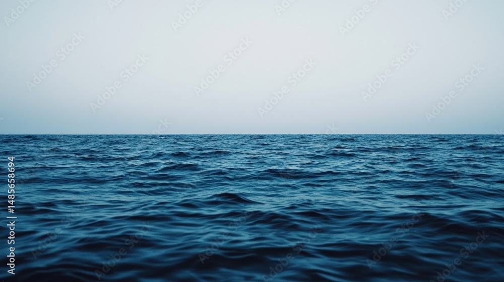 Fototapeta premium Calm ocean waves gently rolling under a serene sky, creating a tranquil scene