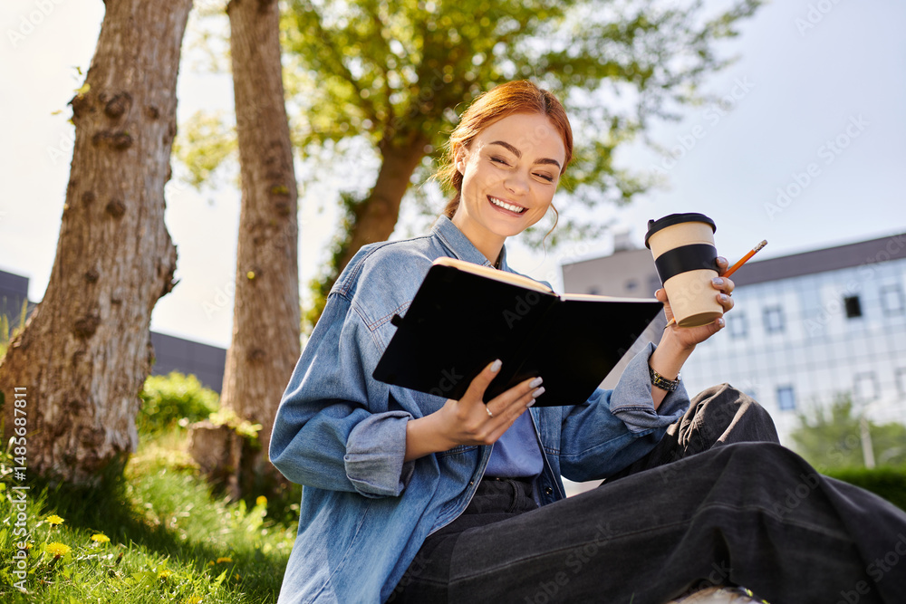 Red haired woman enjoying a sunny afternoon reading and sipping coffee in a park Red haired woman enjoying a sunny afternoon reading and sipping coffee in a park