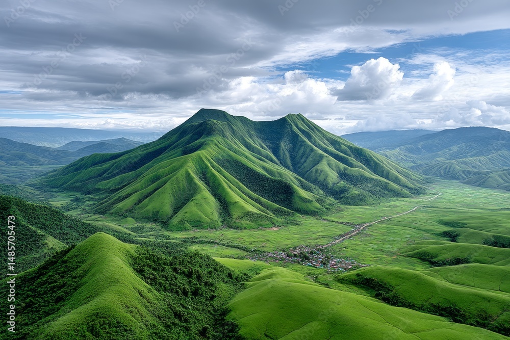 Fototapeta premium A village nestled inside the crater of a green mountain-planet