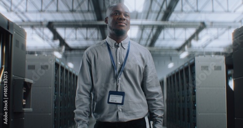Wallpaper Mural Big Data Center with Server Racks: Professional African American Specialist with Tablet Computer Walking In Warehouse, Looking at Camera. Internet Servers, Information Technology and Cyber Security. Torontodigital.ca