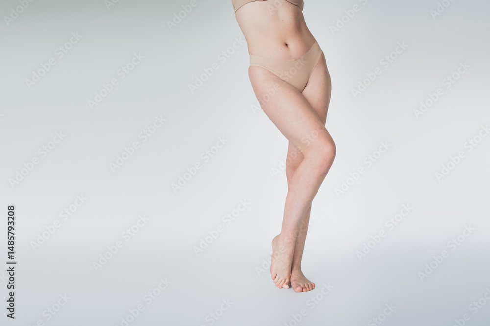 Naklejka premium Elegant depiction of a woman's legs, emphasizing natural beauty and healthy lifestyle in a serene setting.