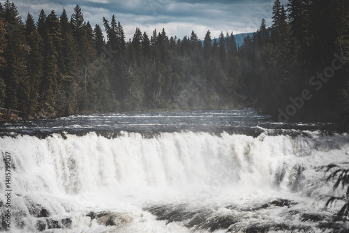 summer clear day in Wells Gray Provincial Park. scenic views of wide and high waterfalls in a outdoor andventurous trip. splashing water, intense green and high contrast light all around