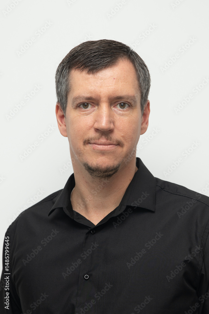 Fototapeta premium Adult man with mustache in black shirt on white background