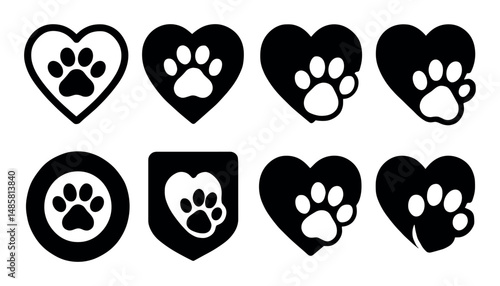 Set of paws inside hearts and shields icons in black silhouette
