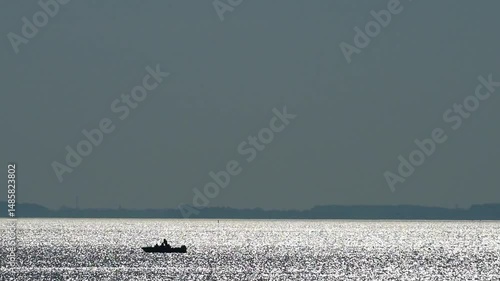 Idyllic shot of the Schaproder Bodden: The shimmering water reflects the blue sky. Boats float by, creating a relaxed atmosphere. Video excerpt 24 sec, 117 MB, rate is 50 pps.