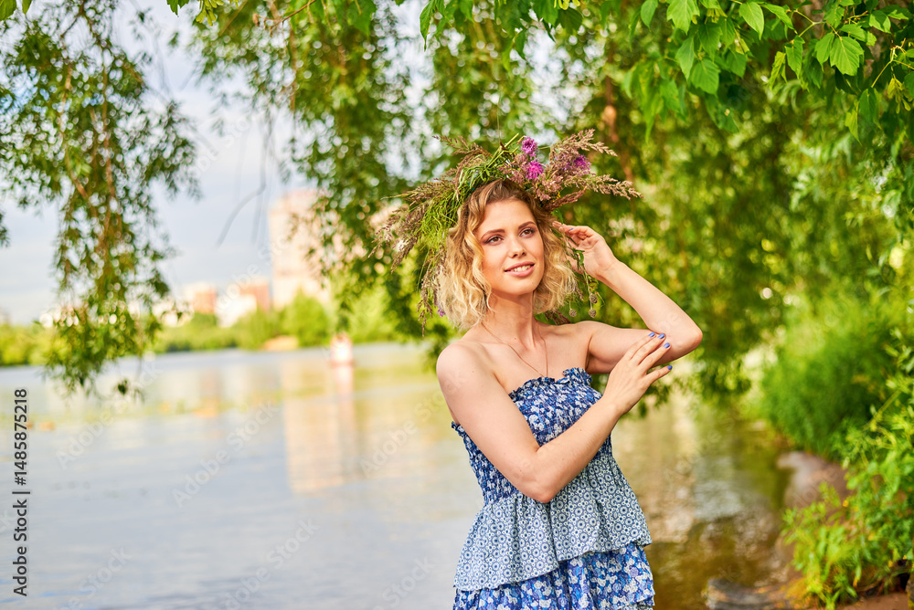 Woman with wreath on her head stands by pond. Scene is serene and peaceful, woman enjoying moment of bliss. She has beautiful figure. Woman with wreath on her head stands by pond. Scene is serene and peaceful, woman enjoying moment of bliss. She has beautiful figure.