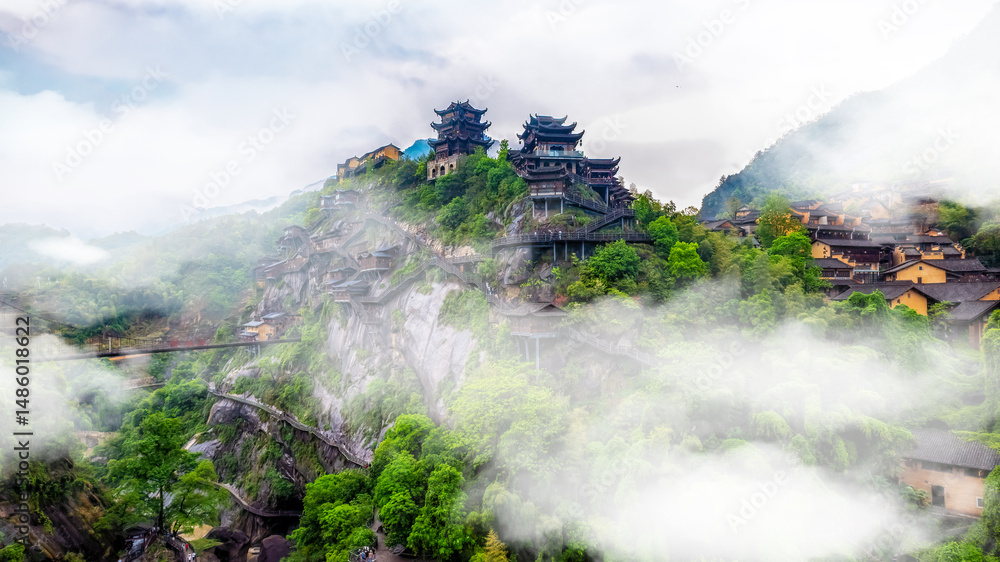 Fototapeta premium Misty Mountain Village with Ancient Structures