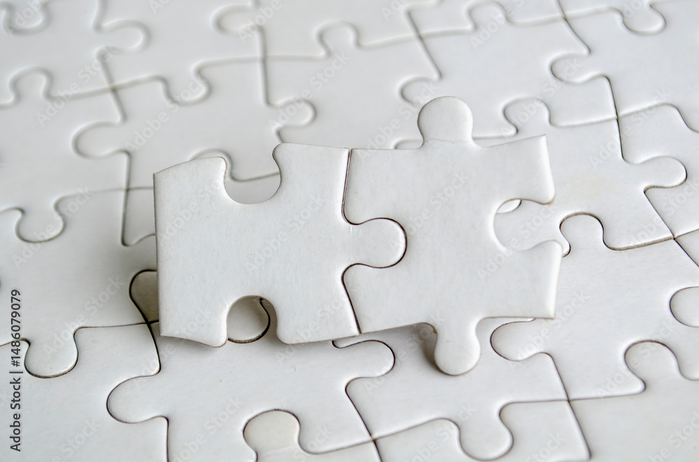 Close up of jigsaw puzzle pieces with customizable space on jigsaw for text or ideas Close up of jigsaw puzzle pieces with customizable space on jigsaw for text or ideas
