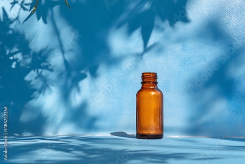 Amber bottle on blue background shadows