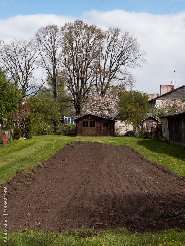 Fotomural Rural Spring Garden with Freshly Plowed Soil