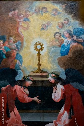 фотографія Painting (19th century) of angels in adoration and prayer front of the Blessed Sacrament