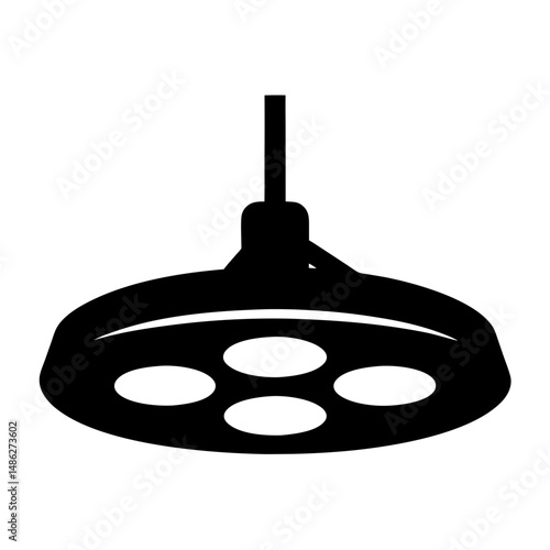 Black and white image of a surgical light with round bulbs