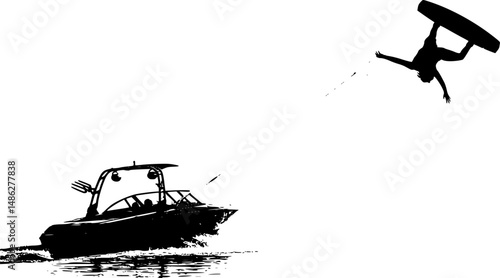 A wakeboard boat pulling a wakeboarder doing a trick.
