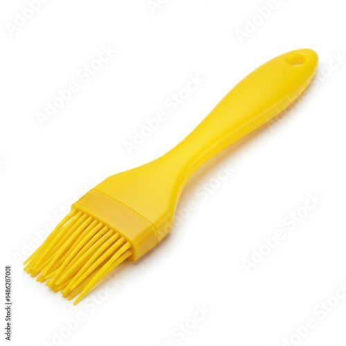 Yellow basting brush isolated on white background for cooking, baking, grilling, and pastry applications.